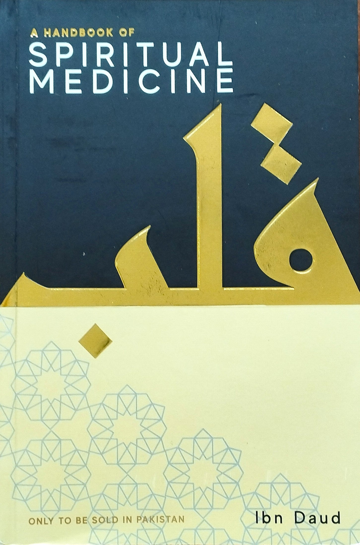Book titled 'A Handbook of Spiritual Medicine' with gold and blue design on cover